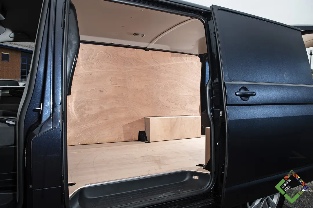 VW Transporter panel van side door open, ply-lined load area